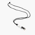 Carica l'immagine nel visualizzatore della galleria, Necklace with a white cylindrical pendant Lovetuner whistle with a waxed cotton necklace on a white background