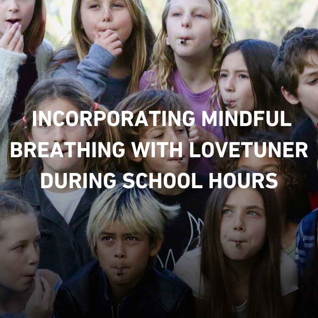 Group of school children practicing mindful breathing with Lovetuner devices during class time, promoting mindfulness in education.