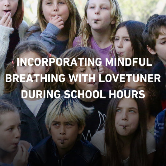 Group of school children practicing mindful breathing with Lovetuner devices during class time, promoting mindfulness in education.
