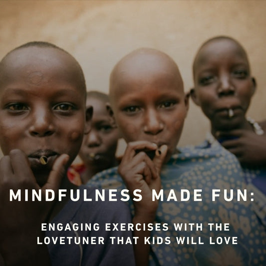 "Four smiling children standing close together, each playing a Lovetuner, promoting mindfulness and joy in a playful group activity."