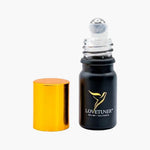 Lovetuner Egyptian Pharaoh Oil 528 Hz roller bottle with gold cap removed, showing the roll-on applicator