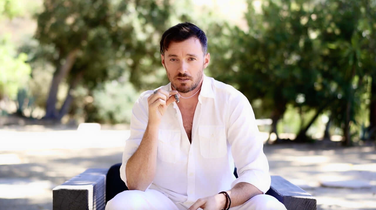 A man with showcasing Lovetuner meditation device around his neck