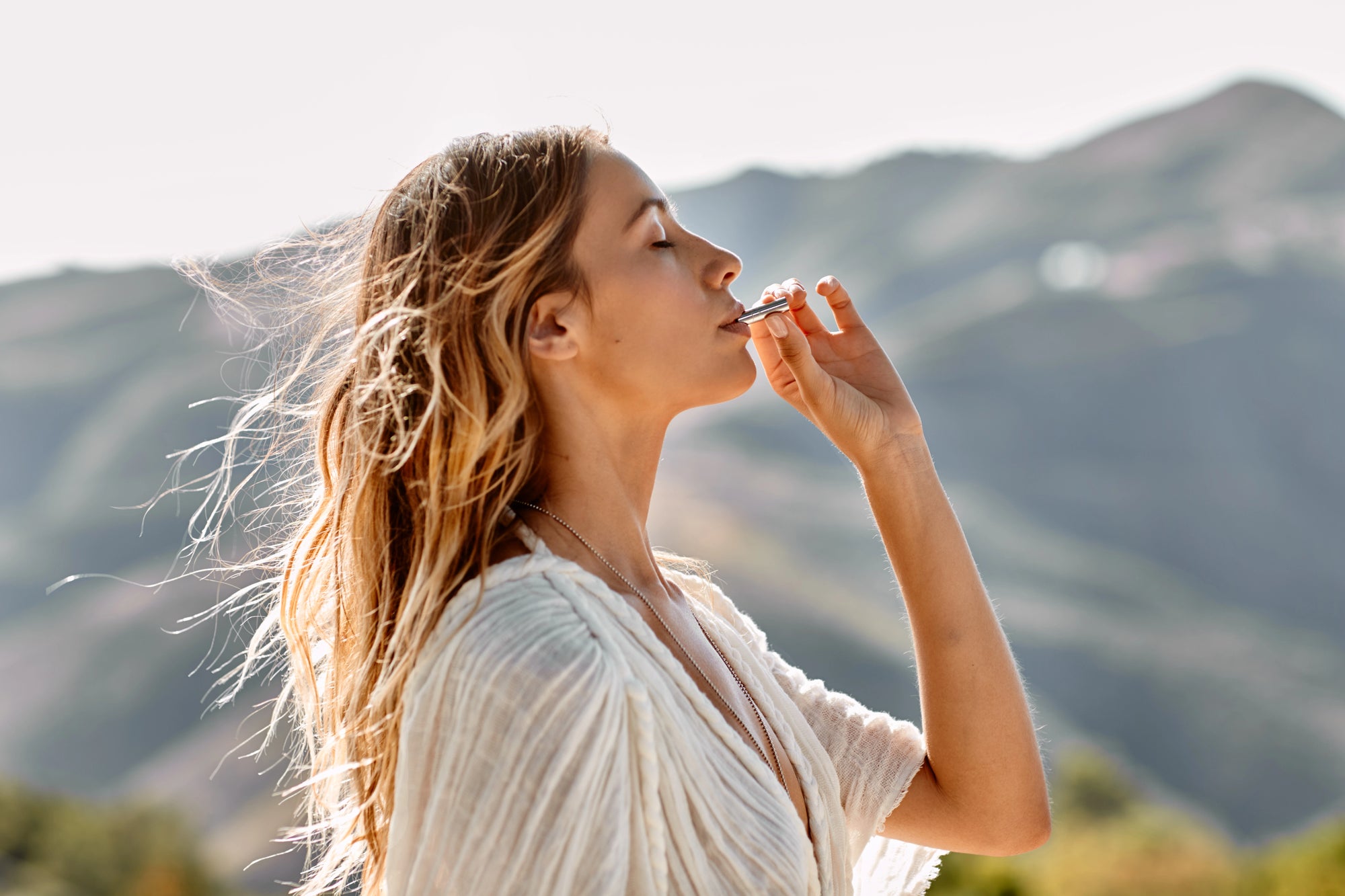 Woman using the Lovetuner with mountains in the background