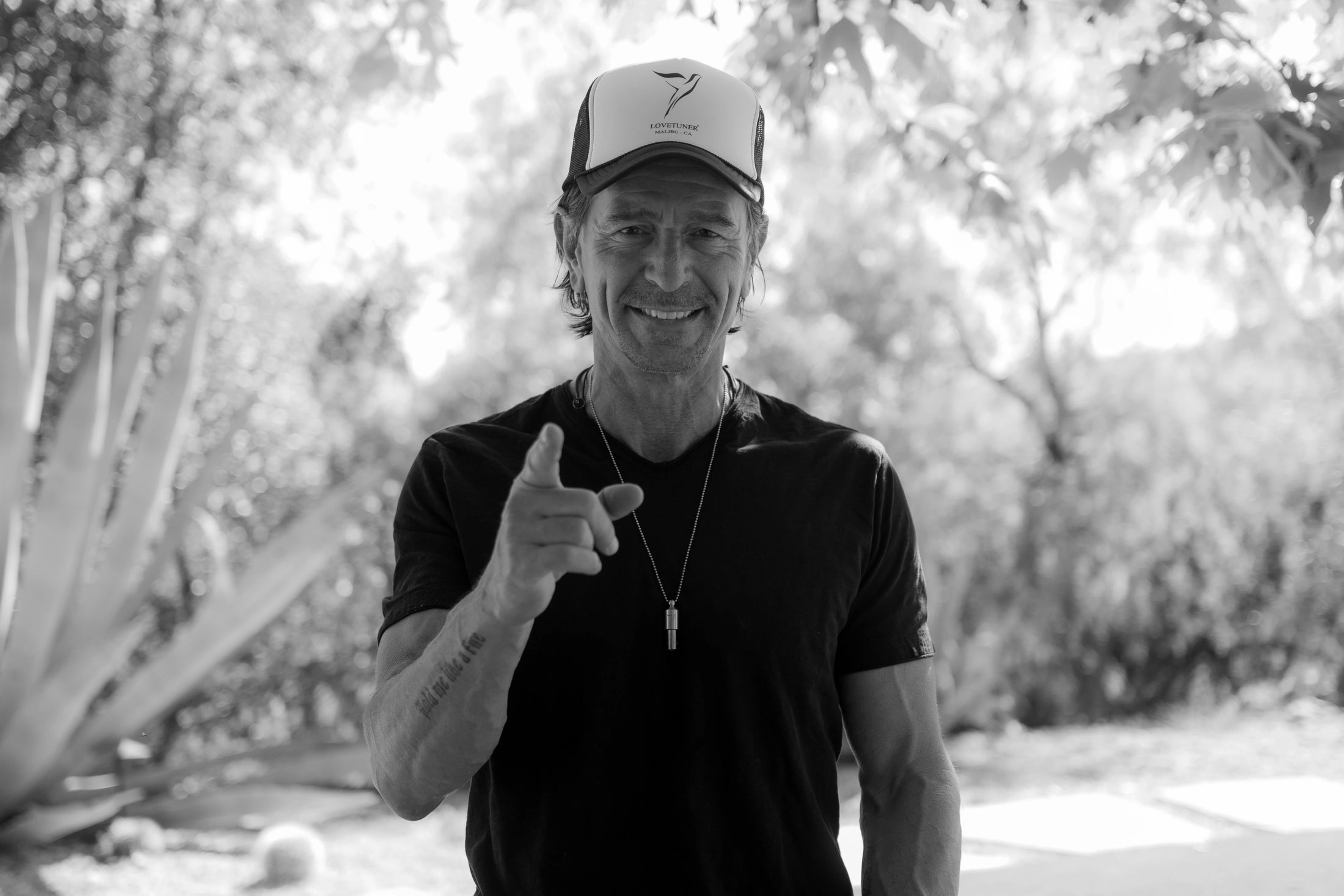 Lovetuner founder Sigmar Berg wearing a cap and black shirt outdoors with trees in the background