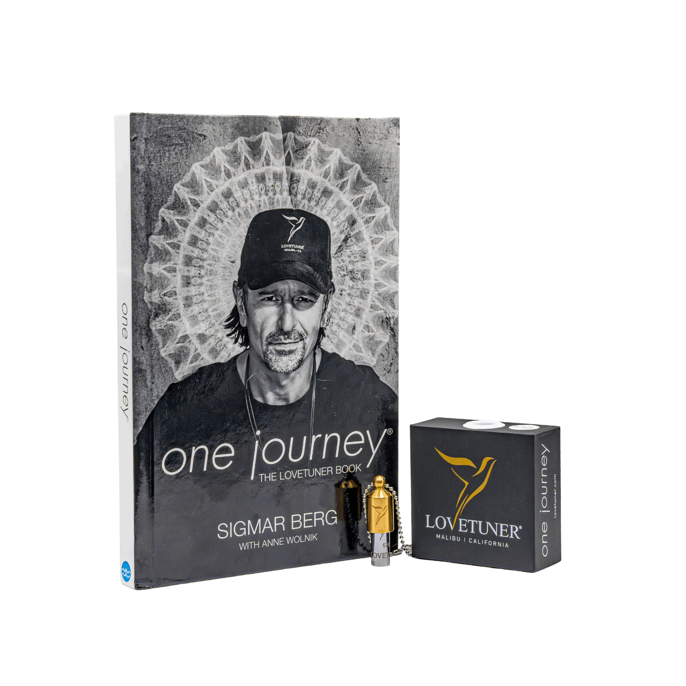Book titled 'One Journey' by Sigmar Berg with Lovetuner product on a white background