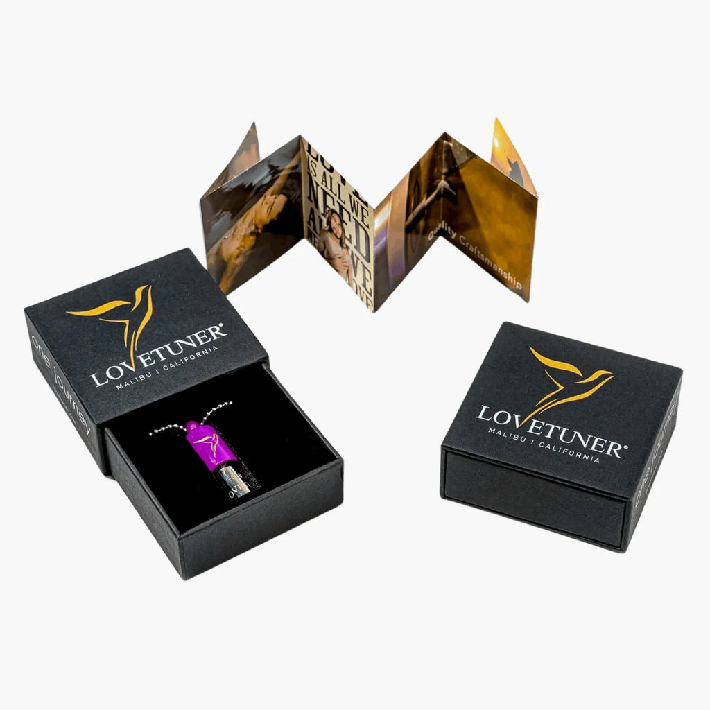 Lovetuner product in a black box with a gold bird on the lid on a white background