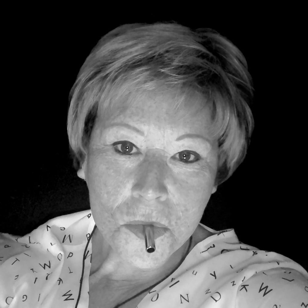 A black and white photo of a woman with short hair using the Lovetuner