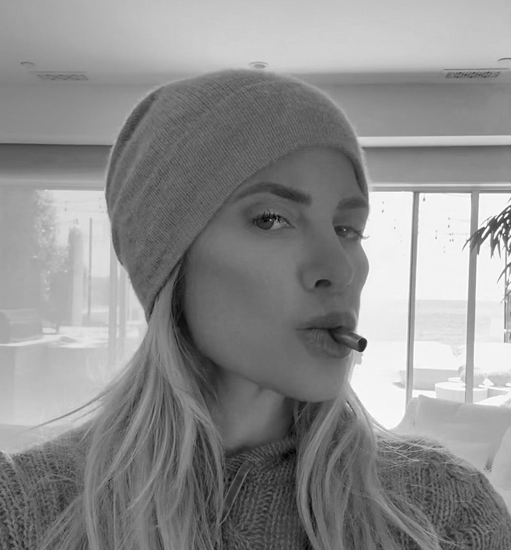 Black and white photo of a woman in a beanie using the Lovetuner